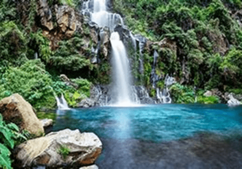 Cascade se déversant dans une vasque turquoise cascade qui se jette dans une vasque d'eau bleu turquoise