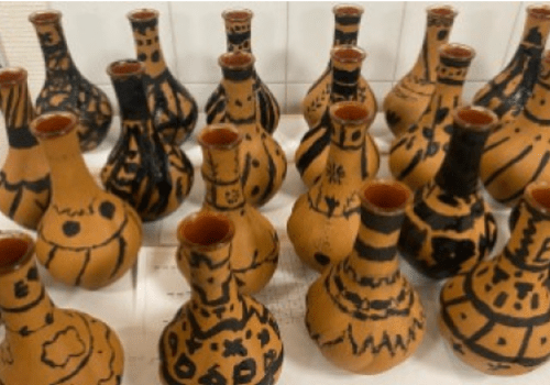 Photographie de productions lors d'un atelier de peinture sur céramique à figures noires