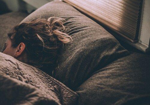 Femme dormant sous des couvertures