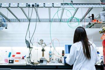 Femme de dos en bouse blanche dans un laboratoire de recherche